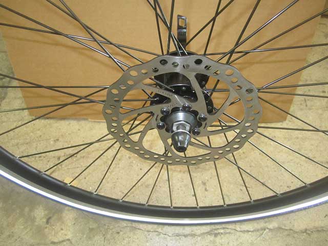 Slide quick release through axle, replace spring and locknut on shaft.