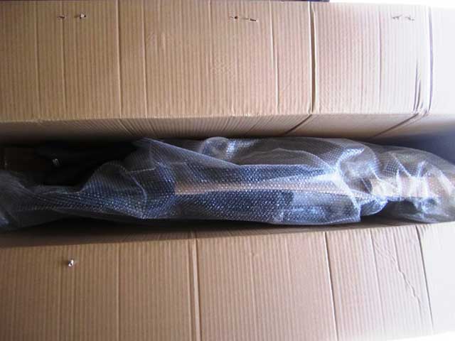 Open box to expose bike, being careful of sharp staples.