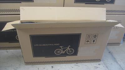 1. Set Ebike box upright, remove strapping, cut open along top edge, exposing the bike, being careful of the sharp staples.