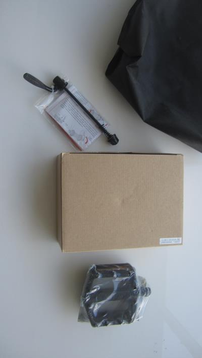 11. Take the front wheel quick release lever from the black bag. Remove locknut and spring. Slide quick release through axle, replace spring and locknut on shaft. Turn locknut only a few turns so it’s loose for easy wheel installation.