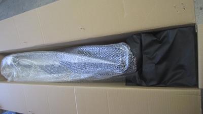 2. Remove the black bag, it contains your pedals, battery charger, and front wheel quick release lever.